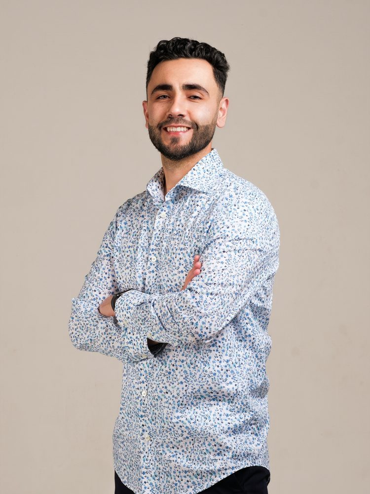 Chafik, arms crossed, smiling
